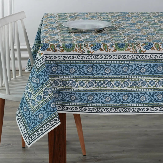 Tablecloth with floral and border design on a wooden table