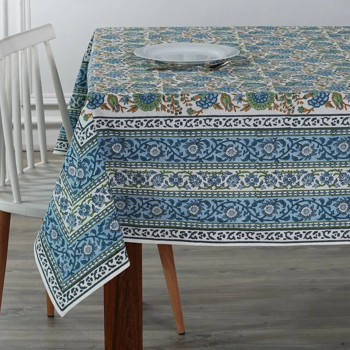 Tablecloth with floral and border design on a wooden table