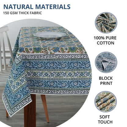 Tablecloth with blue and green patterns on a table, featuring text about natural materials and fabric details.