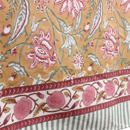 Floral patterned fabric with pink and white flowers on a beige background