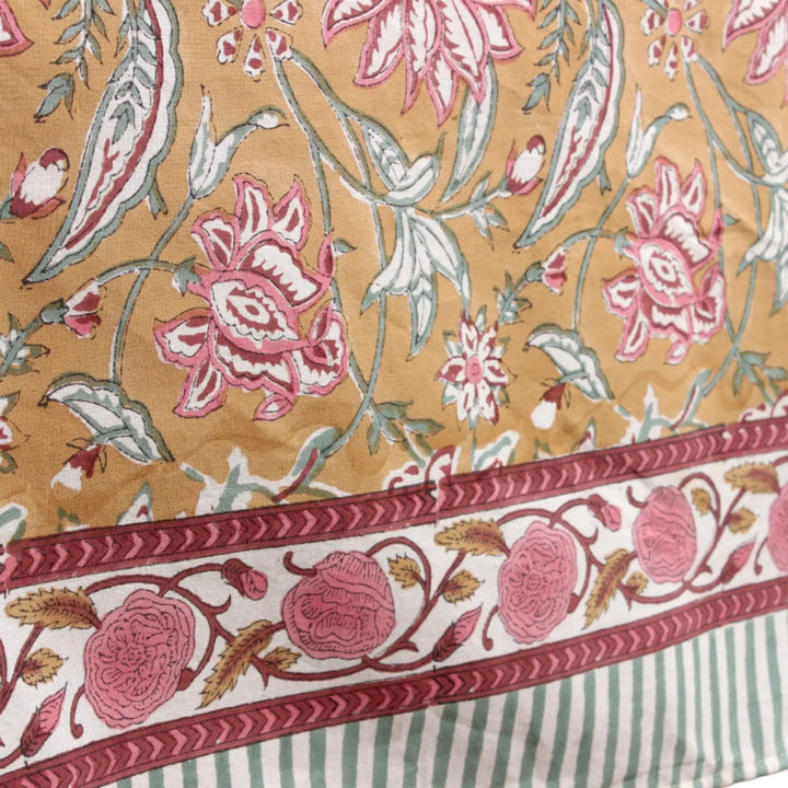 Floral patterned fabric with pink and white flowers on a beige background