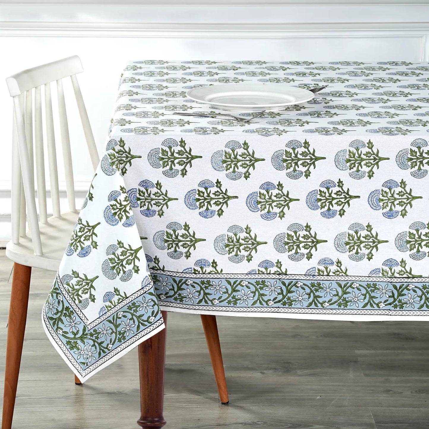 Tablecloth with floral pattern on a wooden table and chair