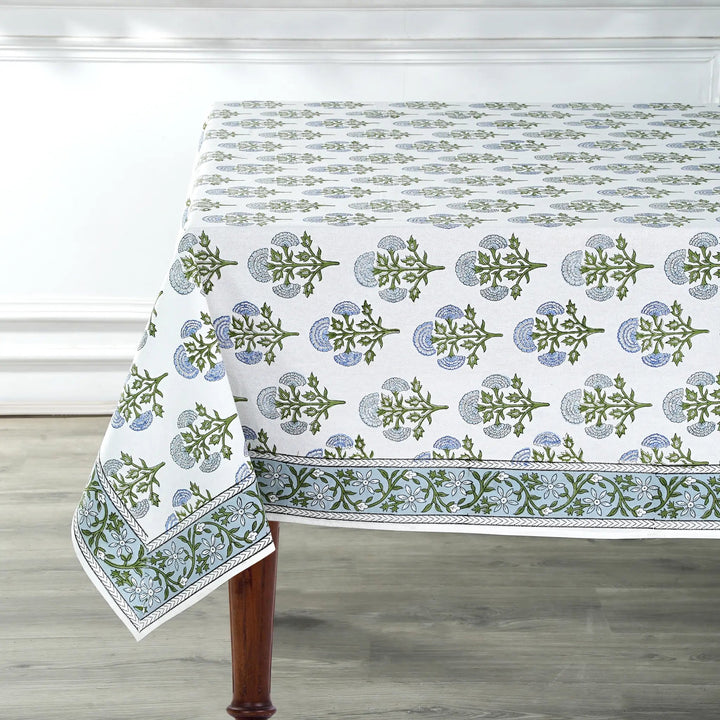 Tablecloth with green floral pattern on a wooden table