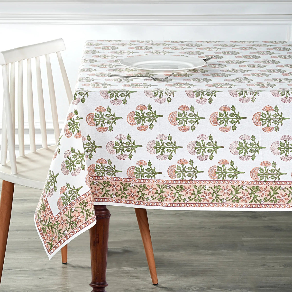 Tablecloth with floral pattern on a wooden table and chair