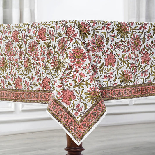 Floral patterned tablecloth on a wooden table with a white background