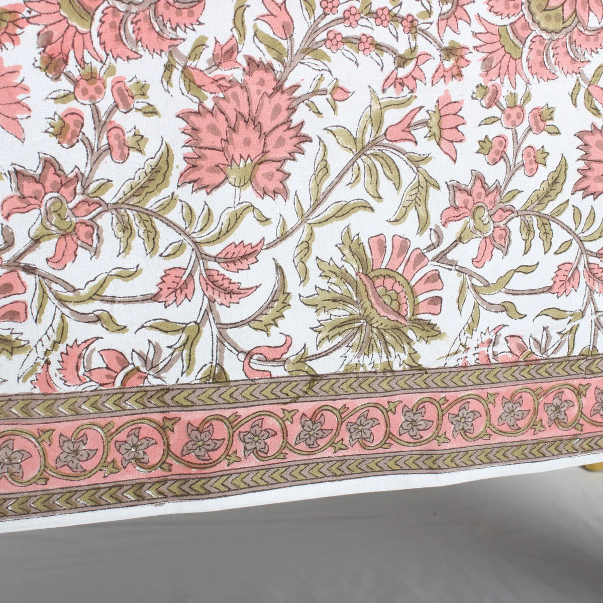 Floral patterned fabric with pink and green flowers on a white background