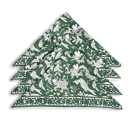 Set of green and white patterned napkins stacked on a white background