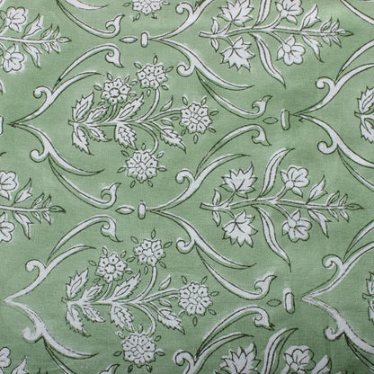 Green fabric with white floral and leaf pattern