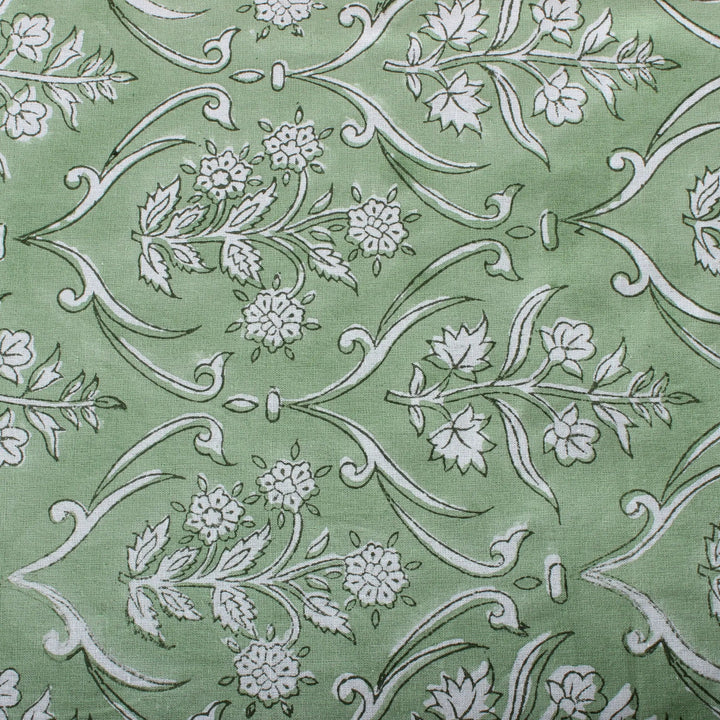 Green fabric with white floral and leaf pattern