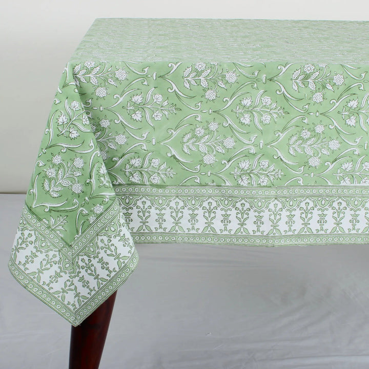 Green floral patterned tablecloth on a white surface