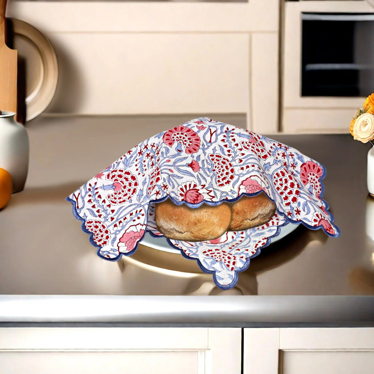 Bread wrapped in a decorative cloth on a kitchen counter