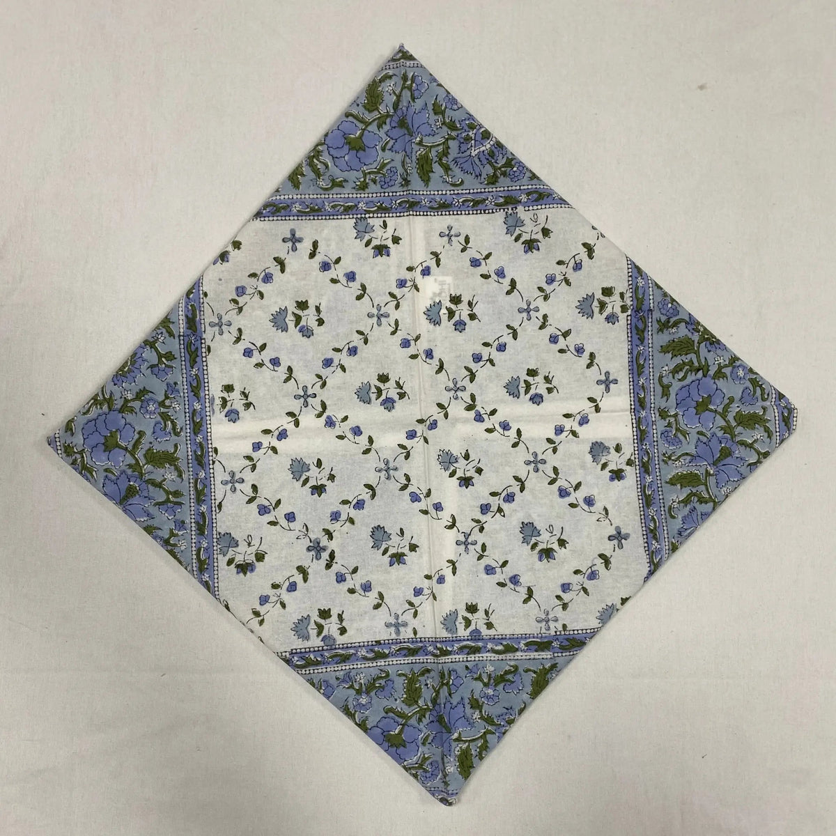 Floral patterned fabric square on a plain background