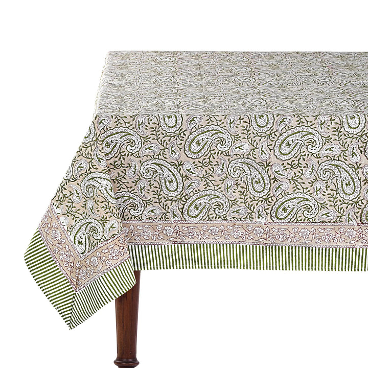 Patterned tablecloth on a wooden table with a white background