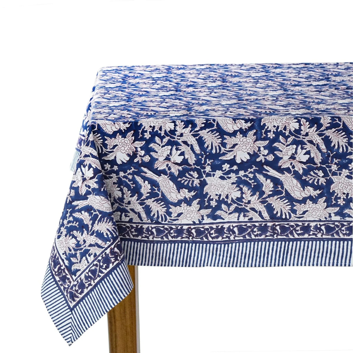 Blue and white floral patterned tablecloth on a wooden table.