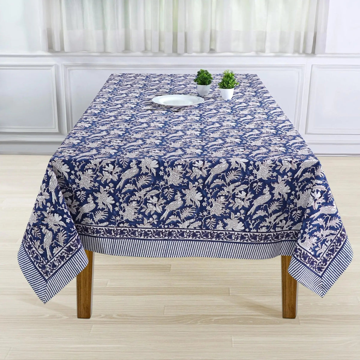 Tablecloth with blue and white floral pattern on a wooden table.