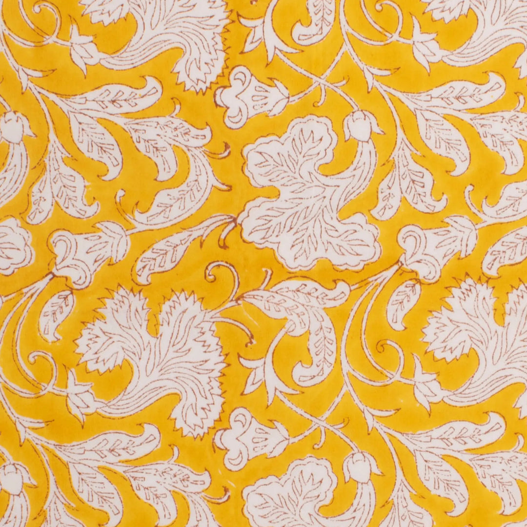 Patterned fabric with white floral design on a yellow background
