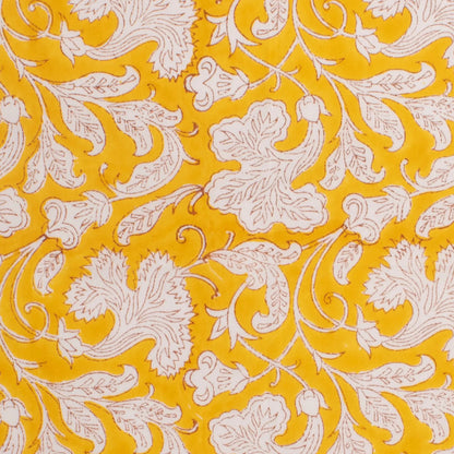 Patterned fabric with white floral design on a yellow background