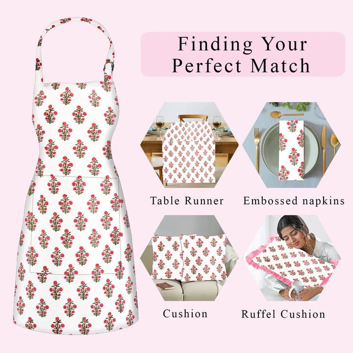Floral apron with matching table runner, napkins, cushion, and ruffel cushion on a pink background.