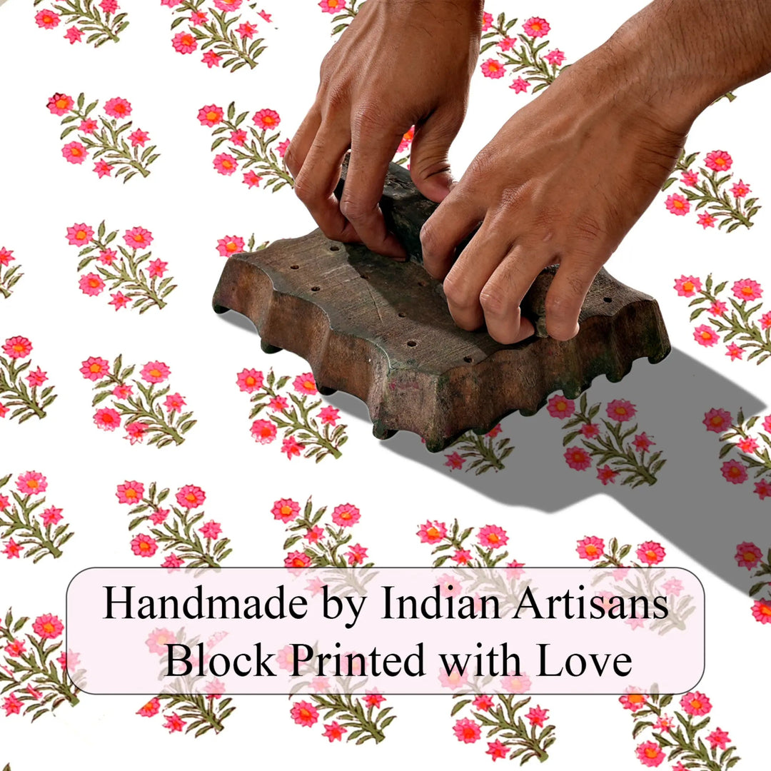 Handmade block printing tool with hands on a floral patterned background