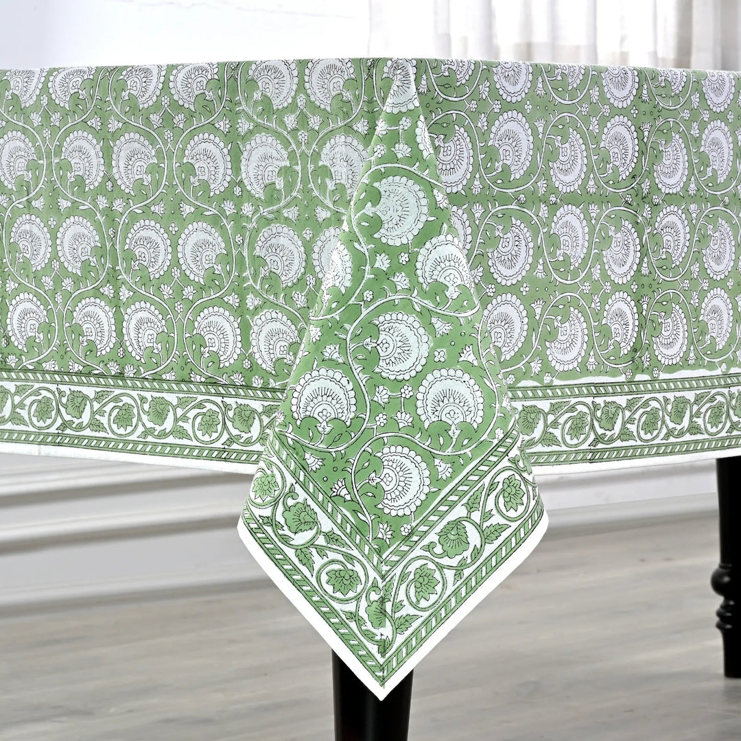Green and white patterned tablecloth on a wooden table.