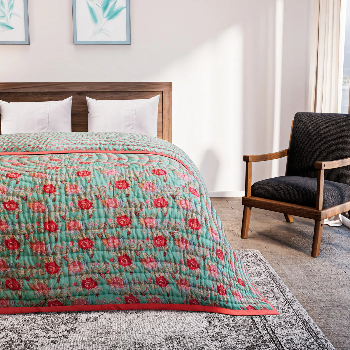 Bed with a floral quilt in a bedroom setting with a chair and artwork on the wall.