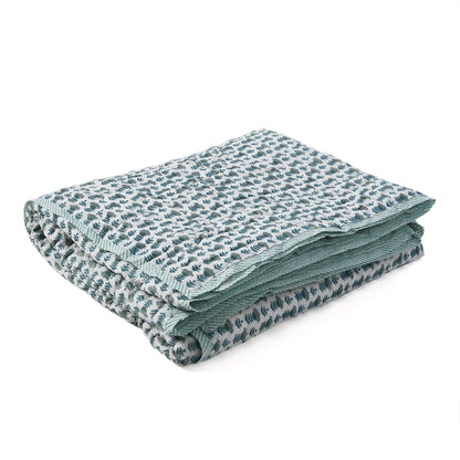 Folded fabric with a subtle pattern on a white background