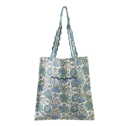 Floral patterned tote bag with a decorative strap on a white background