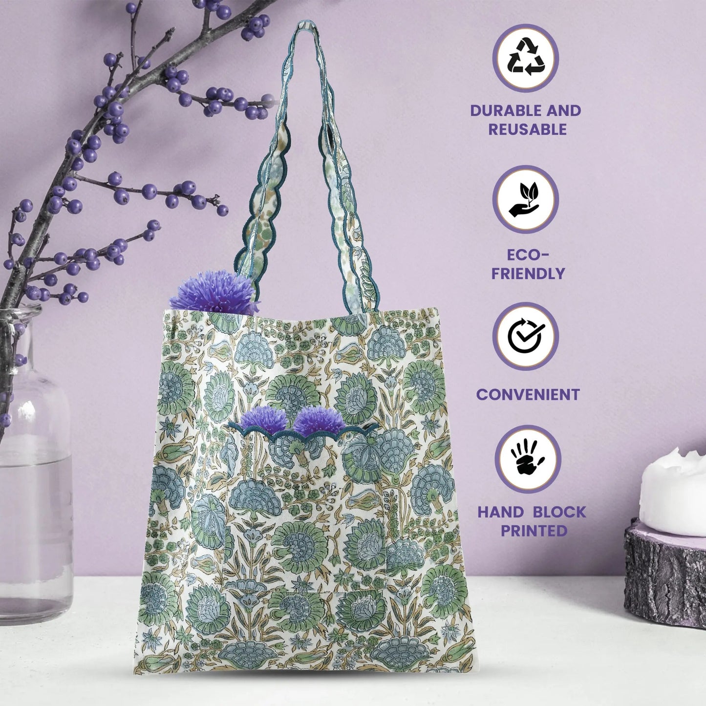 Reusable tote bag with floral design on a white surface with a purple background