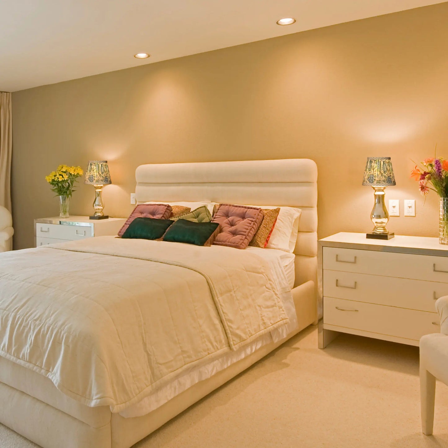 Neatly made bed with decorative pillows in a bedroom setting.