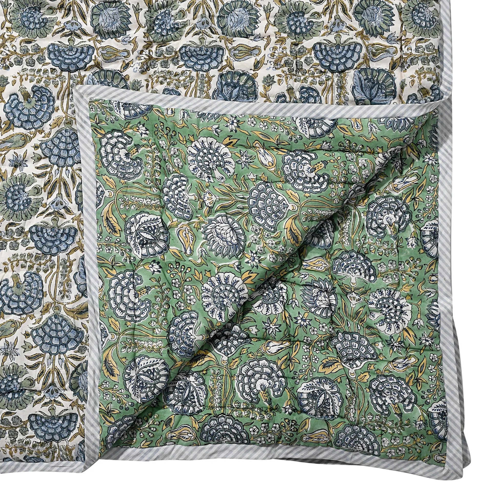 Floral patterned fabric with a green and blue design on a white background