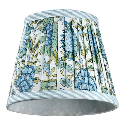Decorative lampshade with floral pattern and striped edges on a white background