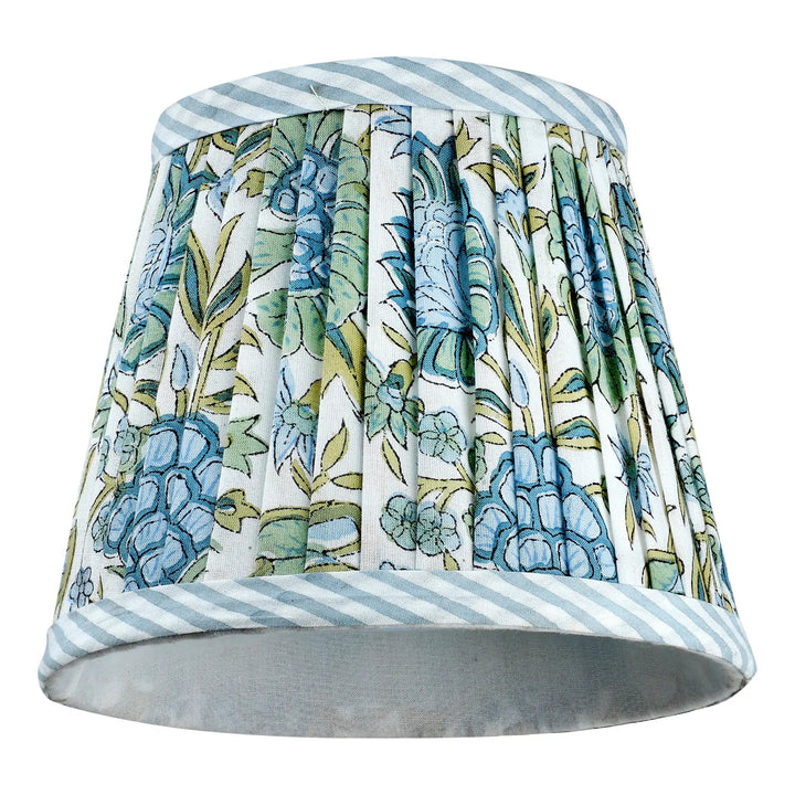 Decorative lampshade with floral pattern and striped edges on a white background