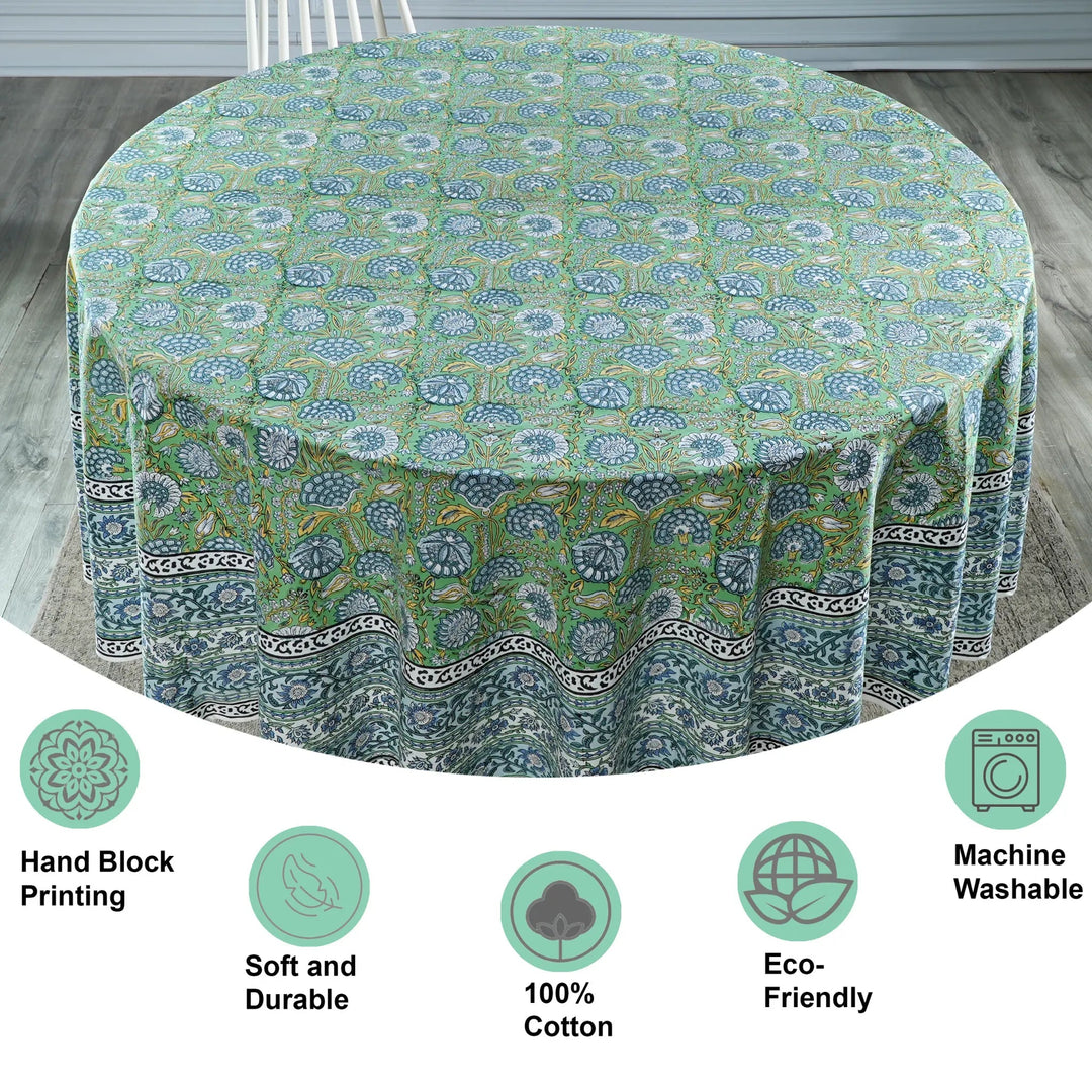 Round tablecloth with green and blue pattern on a wooden floor, featuring icons and text about product features.