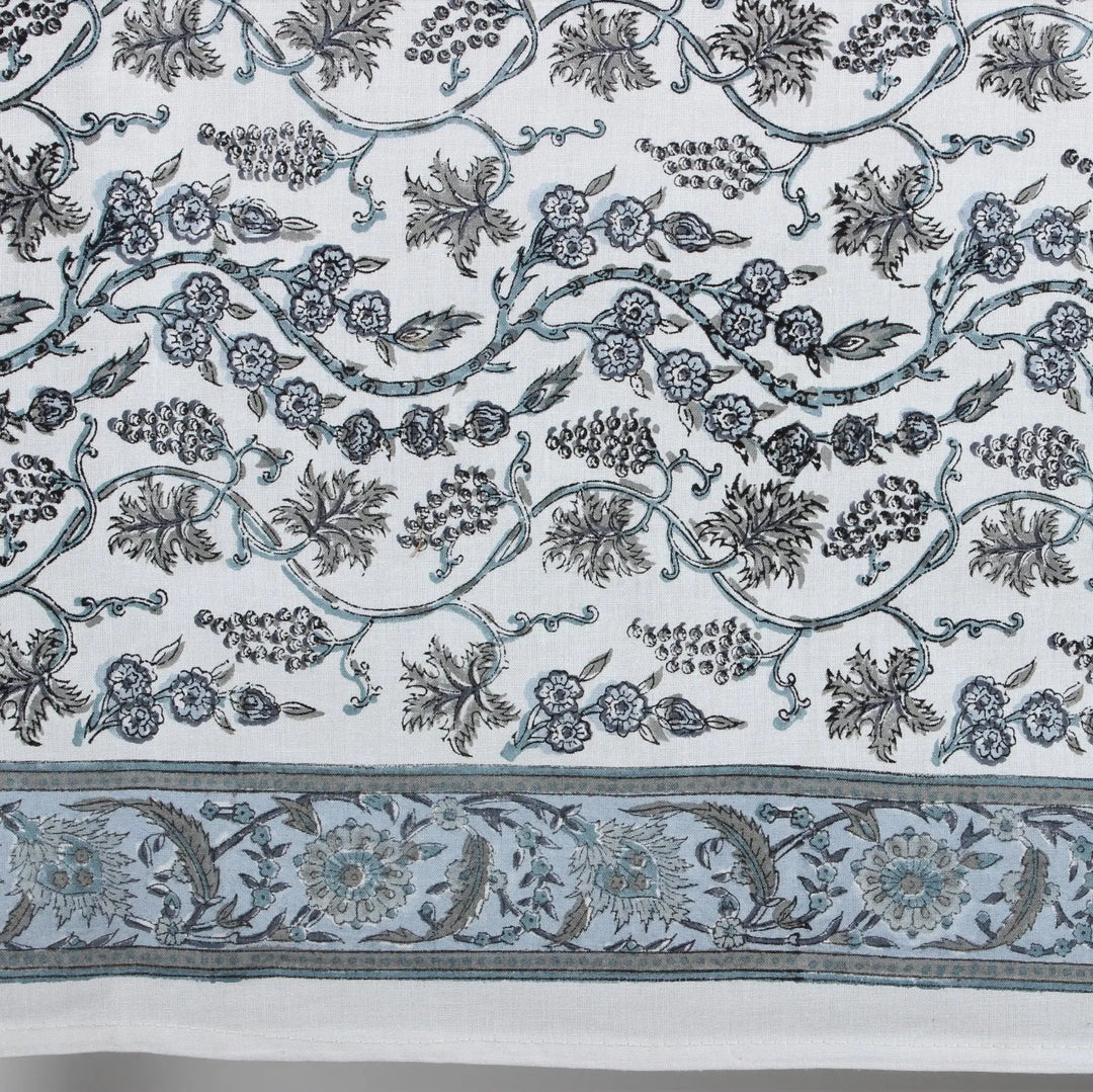 Decorative fabric with intricate floral and leaf patterns on a white background