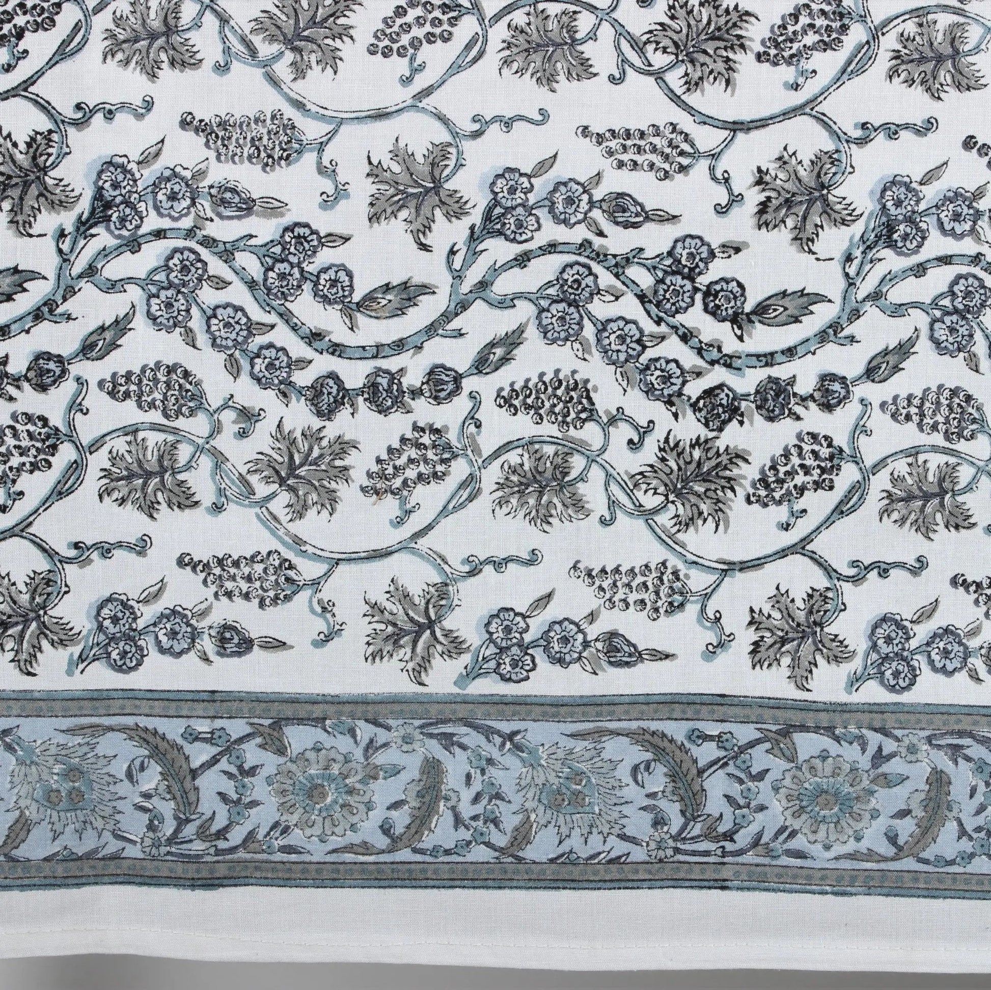 Decorative fabric with intricate floral and leaf patterns on a white background