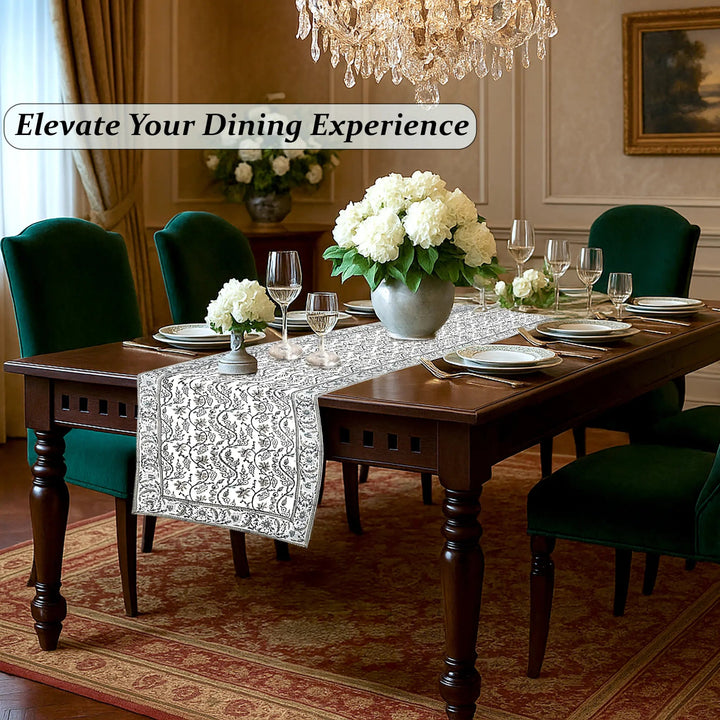 Dining room with a set table, flowers, and a chandelier with text &