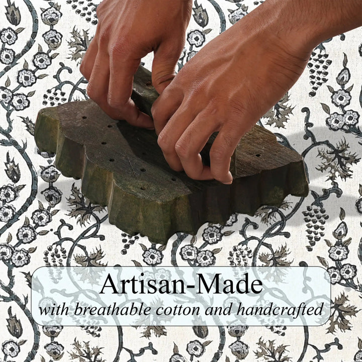 Hands using a textured sponge on a patterned fabric background with &