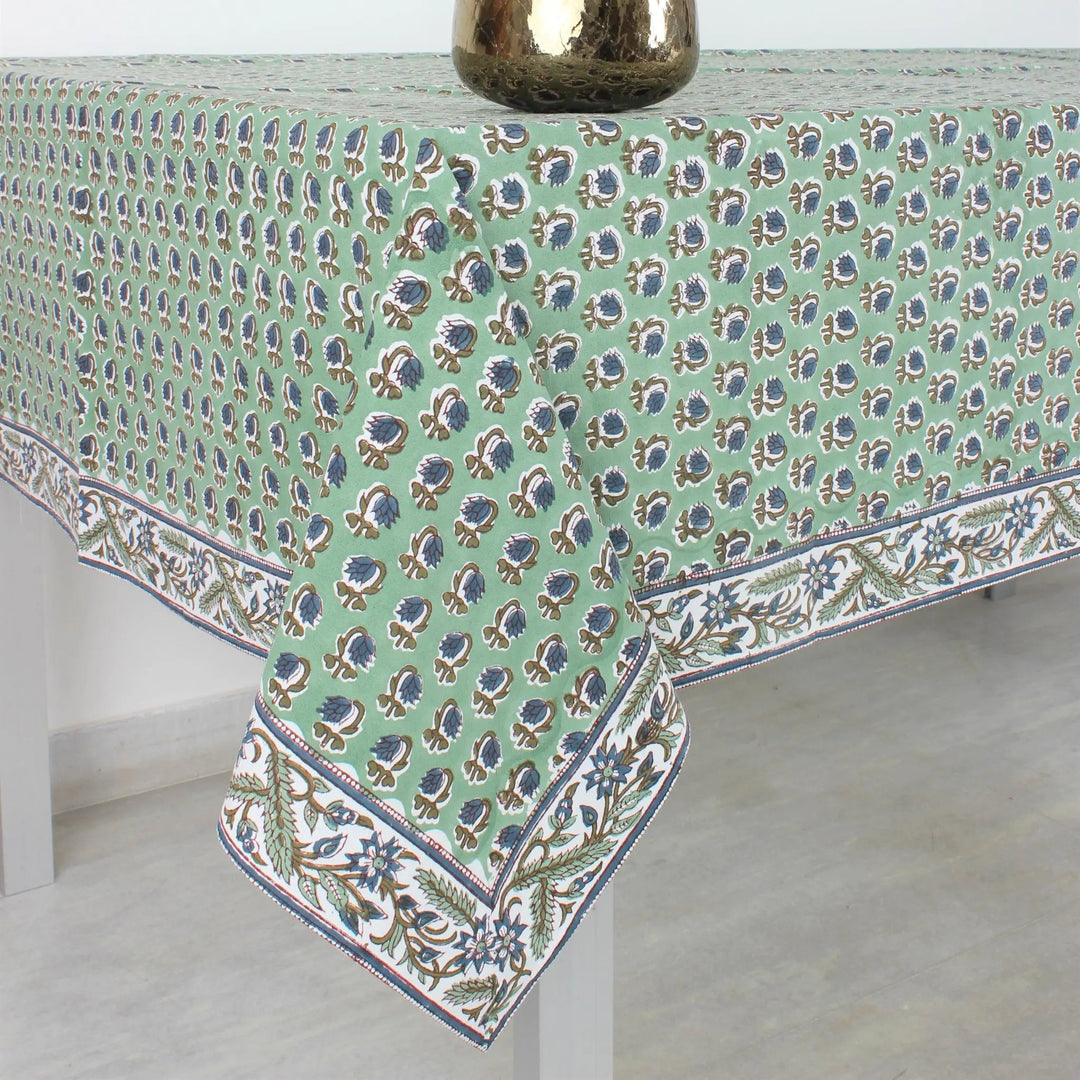 Tablecloth with floral pattern and flowers in a vase on a white background