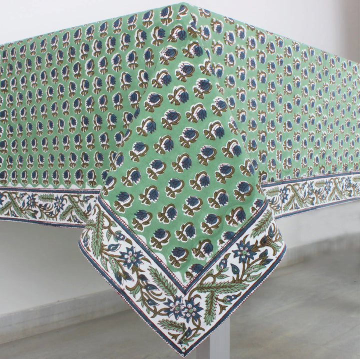 Green floral patterned tablecloth on a white surface