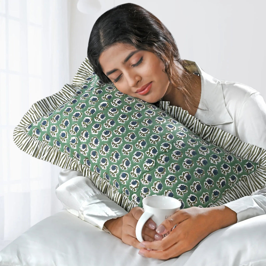 Woman holding a mug with a green patterned pillow on her back
