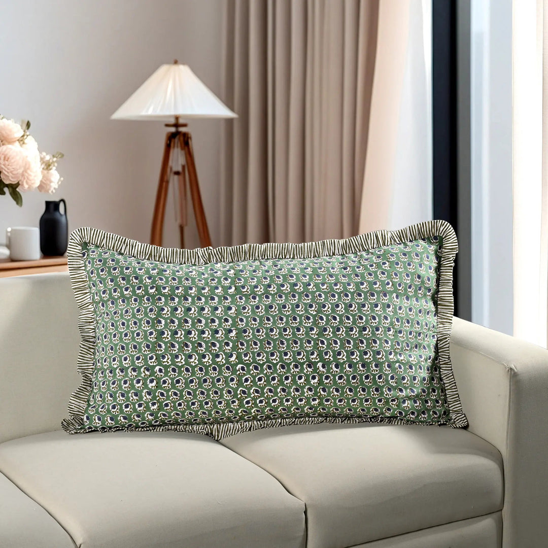 green floral block print cotton pillow styled on a beige sofa in living room.