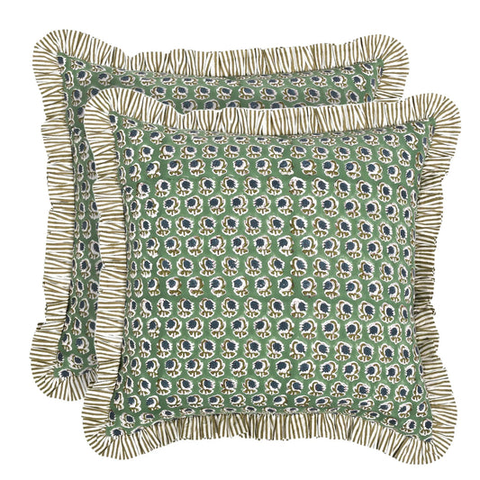 Green patterned pillow with ruffled edge on a white background