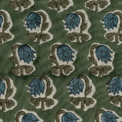 Patterned fabric with blue and brown floral design on a green background
