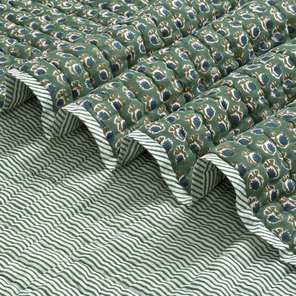 Green patterned fabric with white stripes on a textured surface