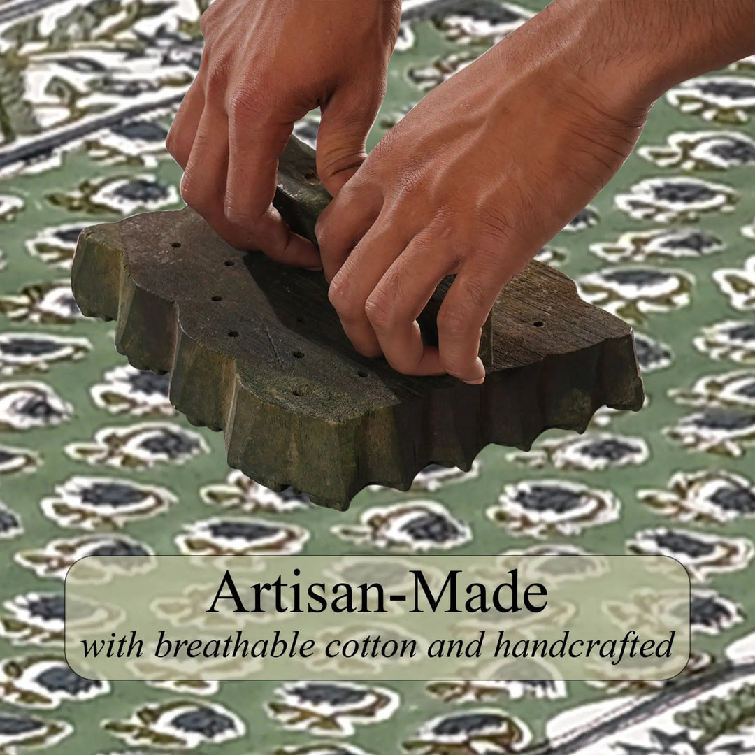 Hands working with a green woven textile on a patterned fabric background, with &