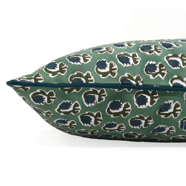 Decorative pillow with a floral pattern on a green background