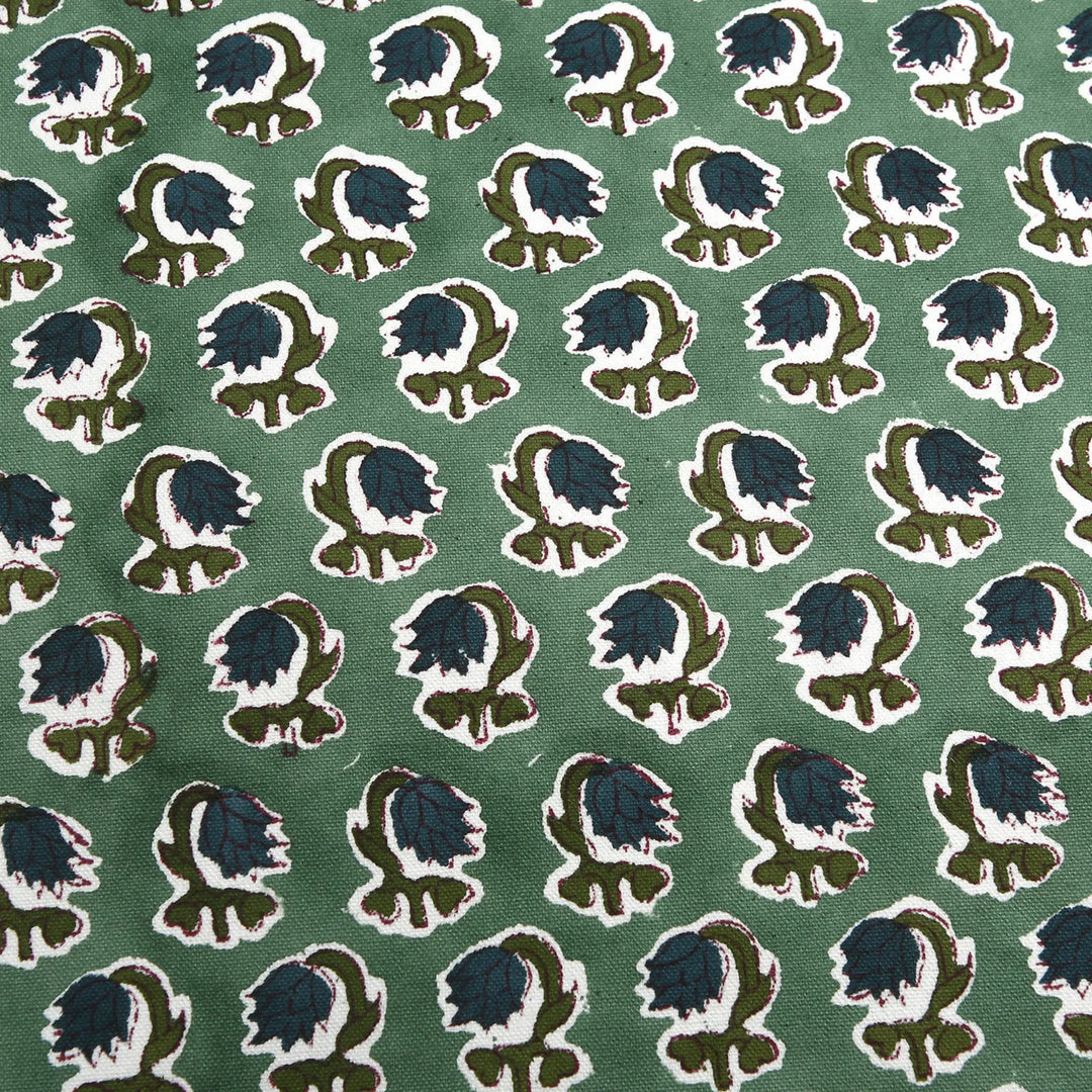 Patterned fabric with blue and green design on a green background