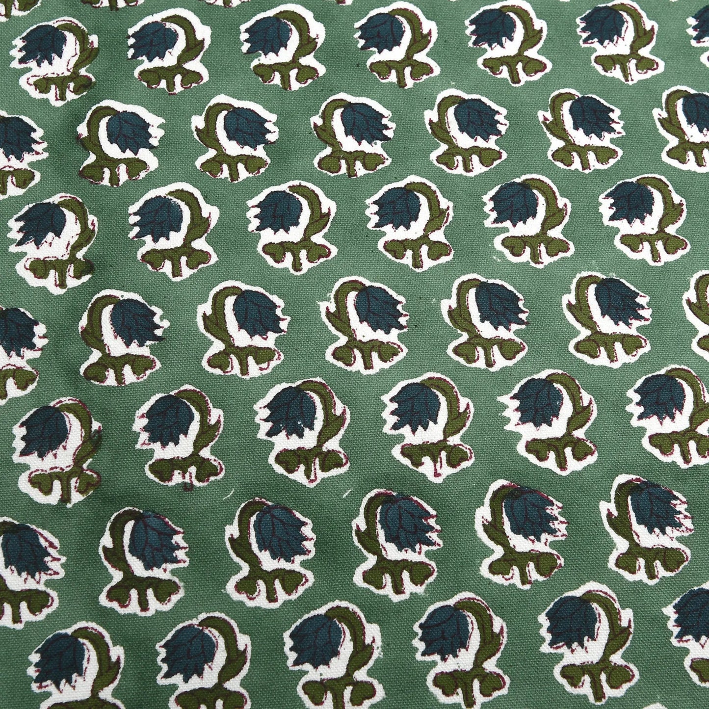 Patterned fabric with blue and green design on a green background