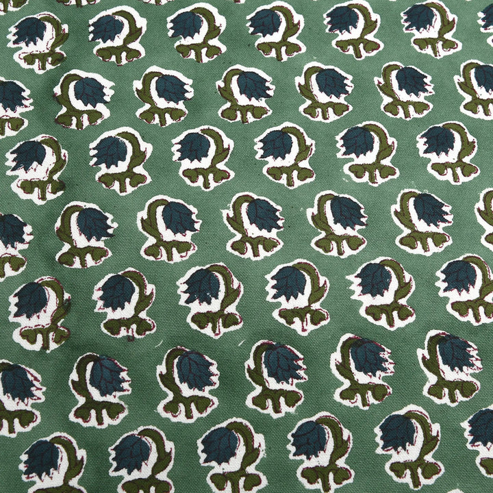 Patterned fabric with blue and green design on a green background