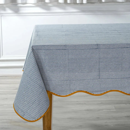 Tablecloth with blue and white striped pattern on a wooden table.